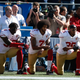 Colin Kaepernick #7 and members of the San Francisco 49ers kneel during the national anthem prior to the game against the Seattle Seahawks at CenturyLink Field on September 25, 2016 in Seattle, Washington.